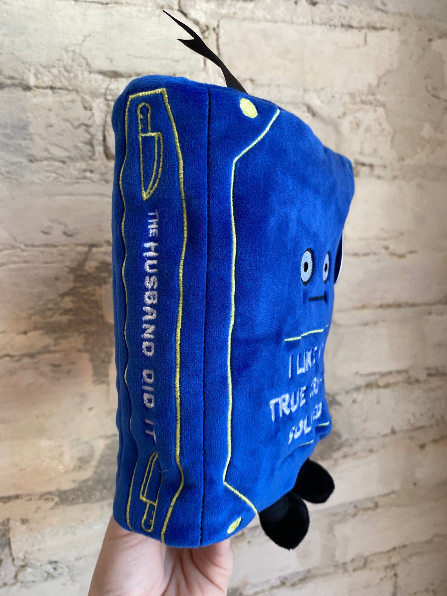“I Like My True Crimes Solved” book plushie