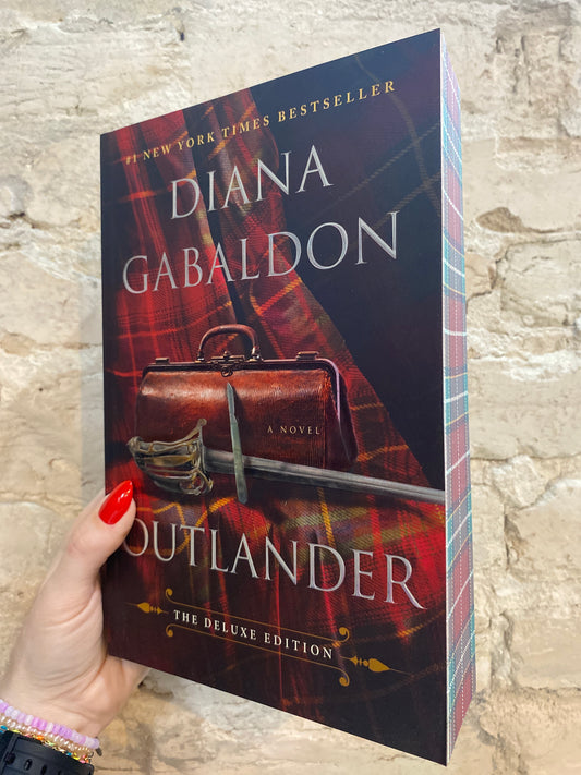 Outlander by Diana Gabaldon (Deluxe Paperback)